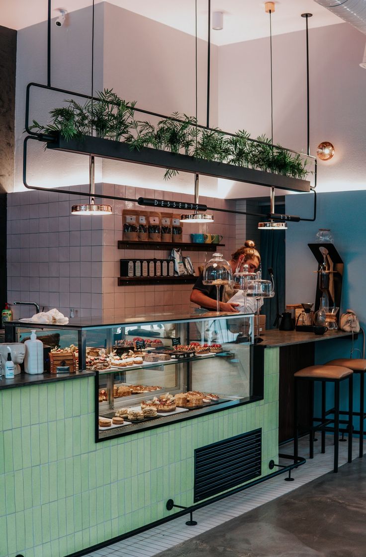 a person behind the counter at a bakery