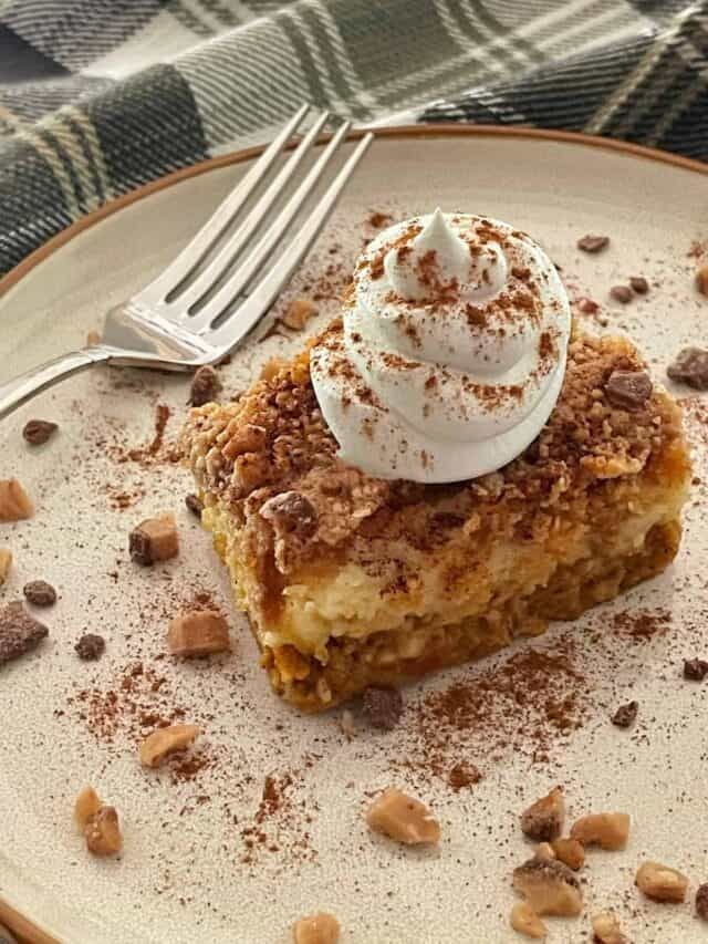 a piece of dessert sitting on top of a plate next to a fork and knife