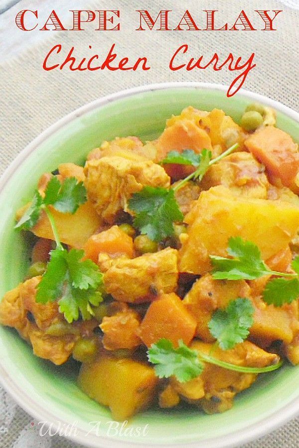 a green bowl filled with chicken curry and vegetables