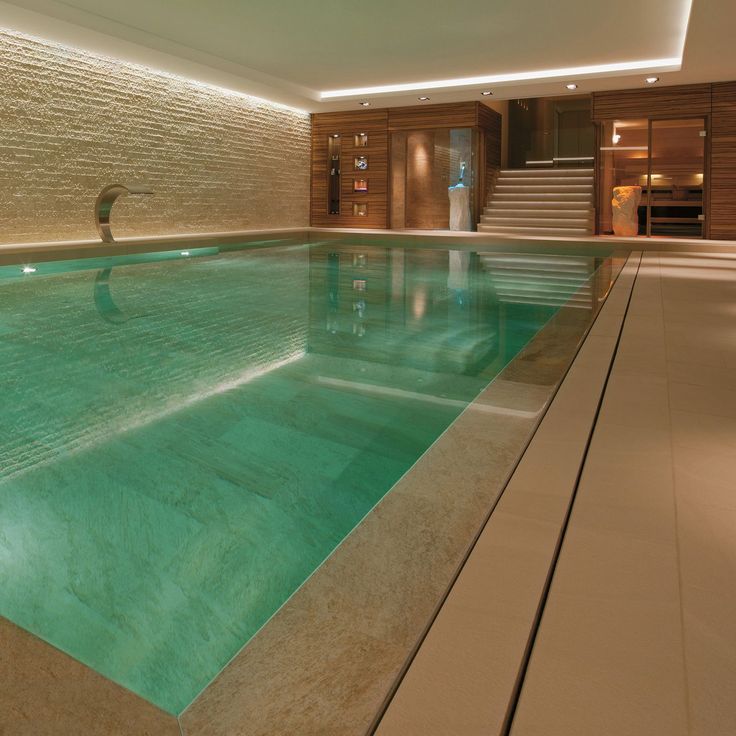 an indoor swimming pool with steps leading up to it