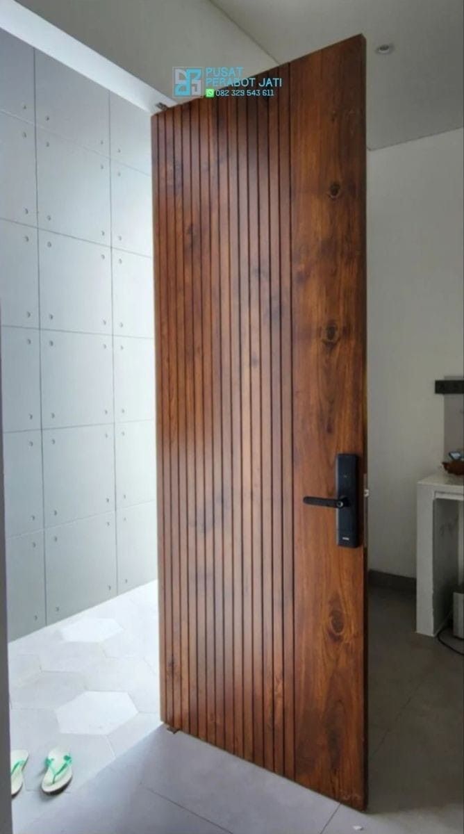 an open wooden door sitting inside of a room