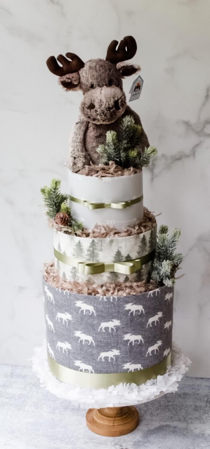 a three tiered cake with an animal on top