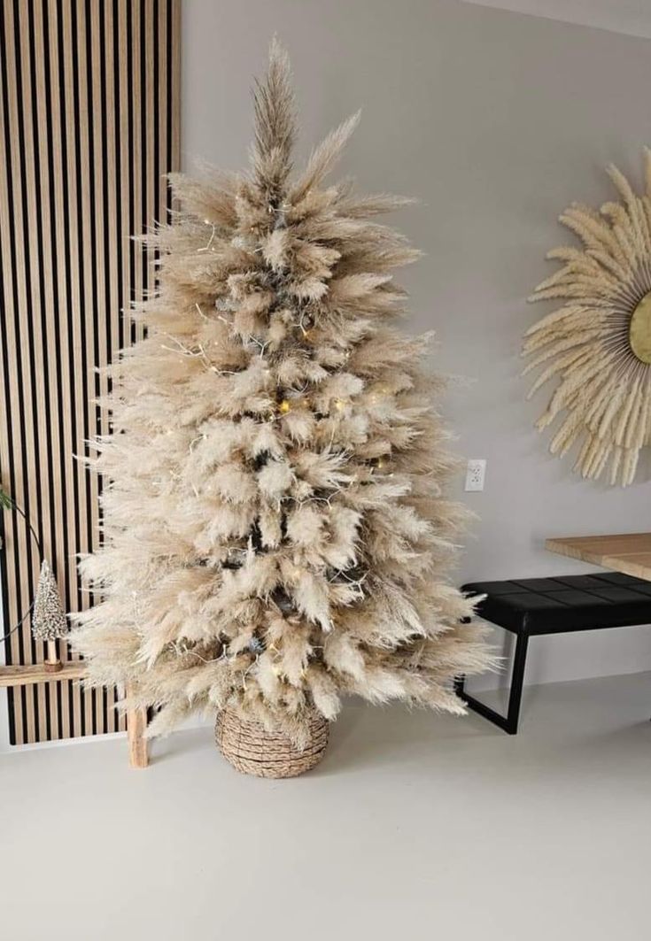 a white christmas tree sitting next to a wooden table