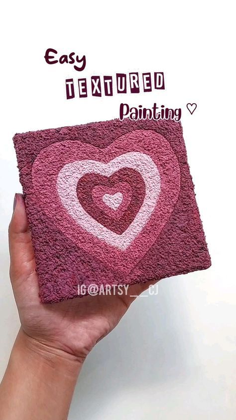 someone is holding up a pink coaster with a heart on it that says easy textured painting