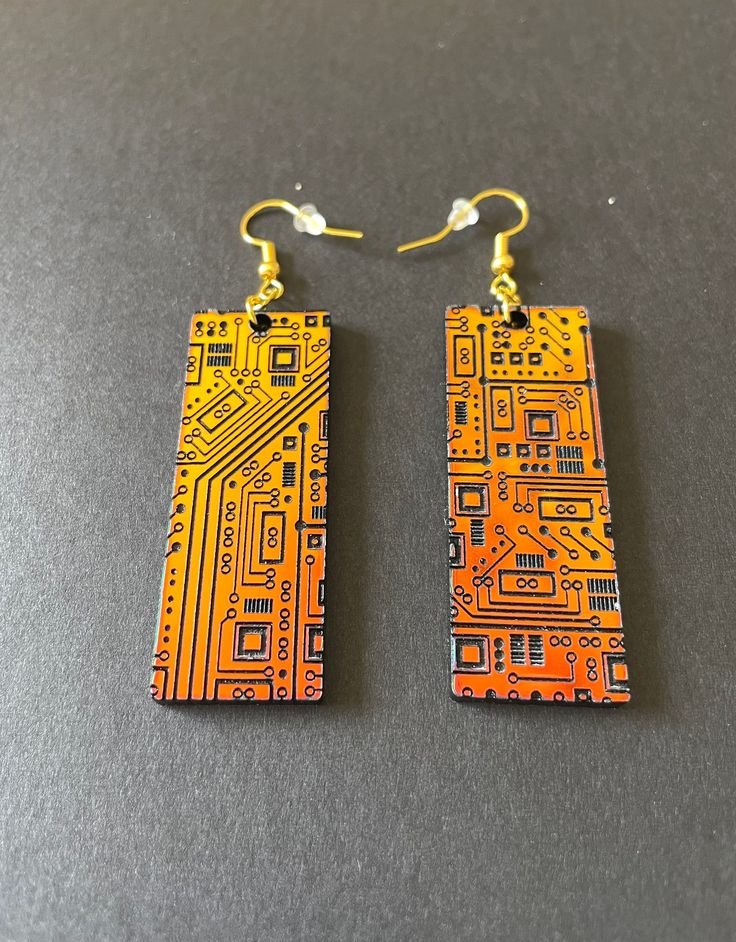 These stunning STEM inspired acrylic earrings are sure to be your favorite pair! An array of circuits decorate these rectangular shaped dangle earrings. The earrings are very lightweight and airy, so they are comfortable to wear all day! The perfect gift for your favorite engineer or STEM professional. Available in several colors - sunset iridescent that shifts from orange to green, or the subtle sparkle silver. Details: * Designed and created by Elishka Jepson * Available colors:    - Sunset ir Cyberpunk Accessories, Tech Jewelry, Watercolor Bookmarks, Acrylic Jewelry, Funky Earrings, Recycled Jewelry, Clay Jewelry Diy, Acrylic Jewellery, Nerd Geek