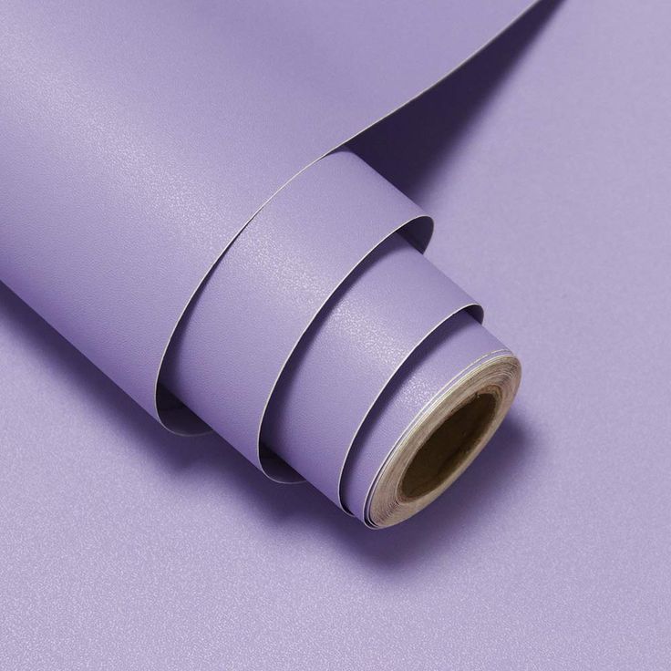 a roll of purple colored paper on top of a table