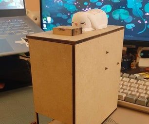 a cardboard box sitting on top of a computer desk