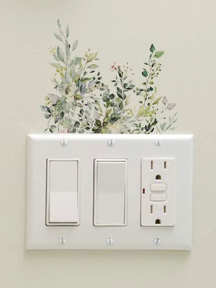 a white light switch sitting next to a wall with flowers painted on the switchesticks