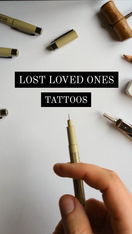 a person holding a pen in their left hand with the words lost loved ones tattoos on it