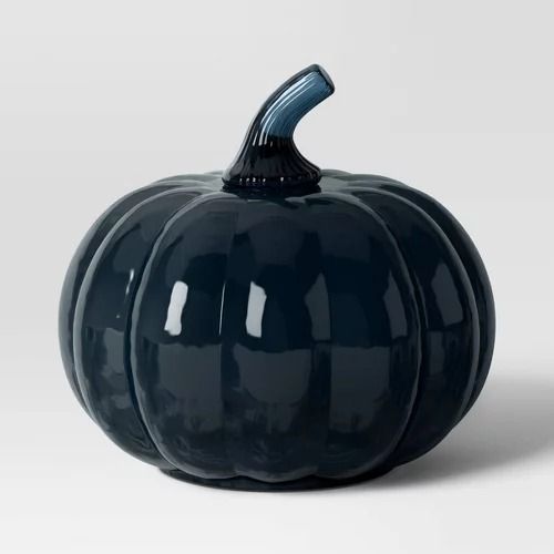 a blue ceramic pumpkin sitting on top of a table