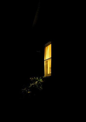 a window lit up in the dark at night