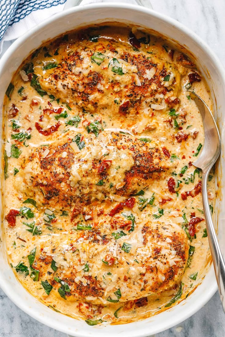 a casserole dish with cheese and spinach on top, ready to be eaten