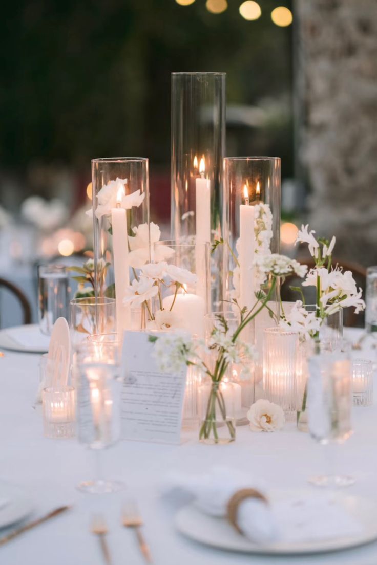 the table is set with candles, flowers and other things to say on the phone