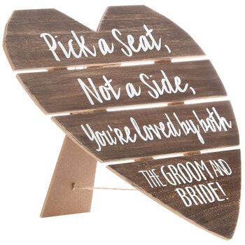 a wooden sign that says pick a seat not a side, you're loved by both the groom and bride