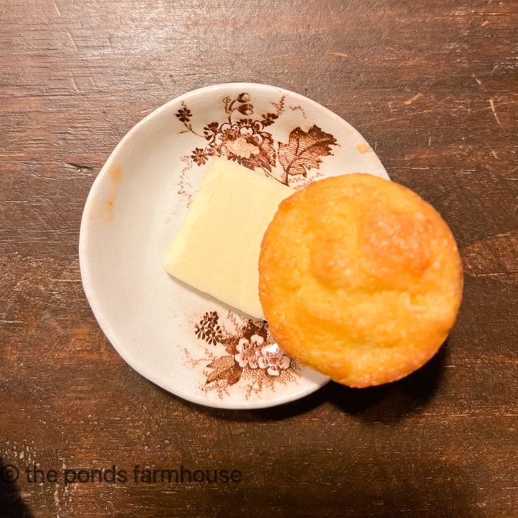 a piece of cheese is sitting on a plate