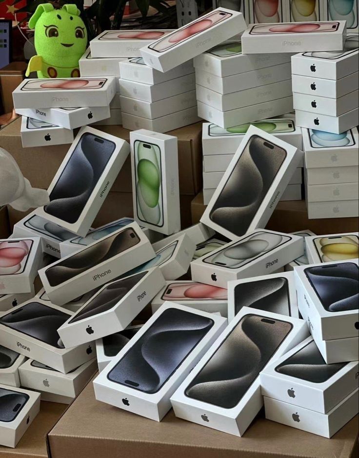 many boxes are stacked on top of each other with an apple phone in the middle