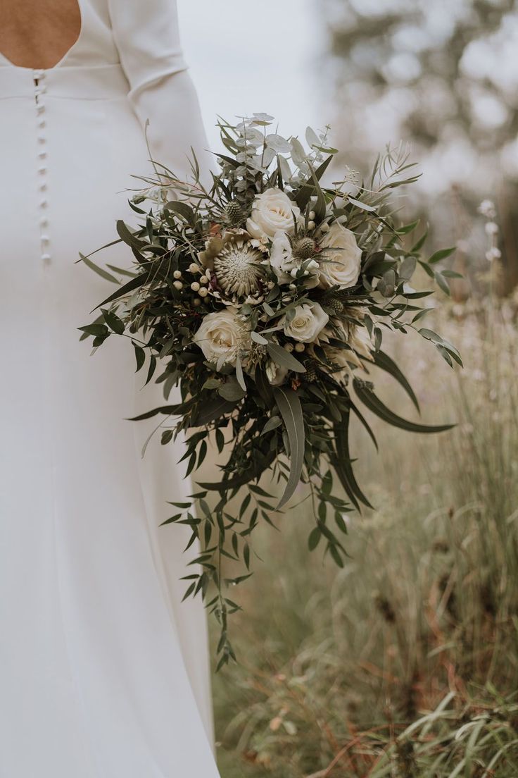 a bride holding a bouquet of flowers in her hand