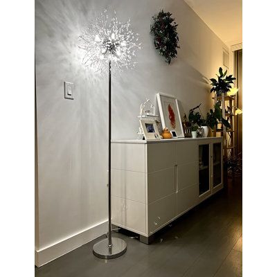 the floor lamp is next to a white cabinet