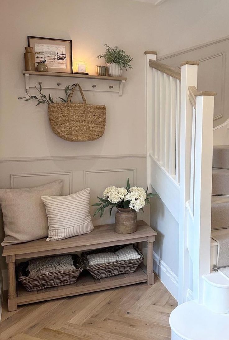 a wooden bench sitting in the middle of a living room next to a stair case