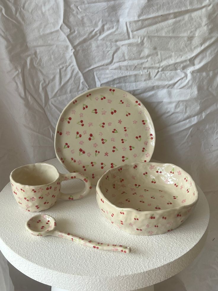 a white table topped with dishes and cups