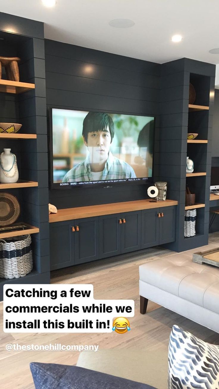 there is a television in the living room with shelves on it and a couch next to it