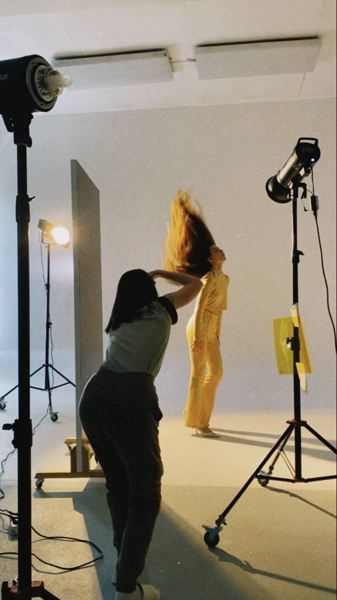 a woman is standing in front of a camera