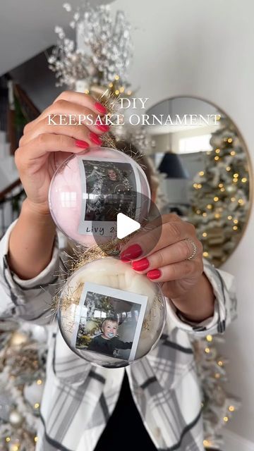 a woman is holding up a christmas ornament