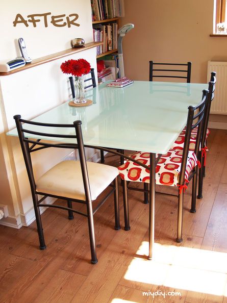 a dining room table with four chairs around it