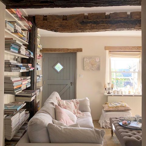 a living room filled with furniture and lots of books