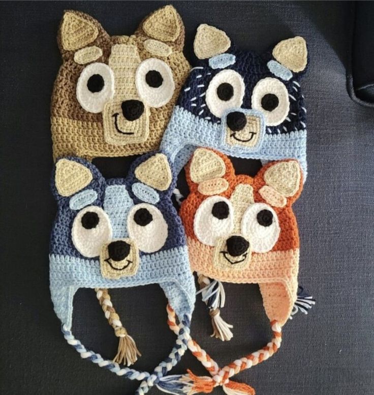 three crocheted hats with eyes and ears