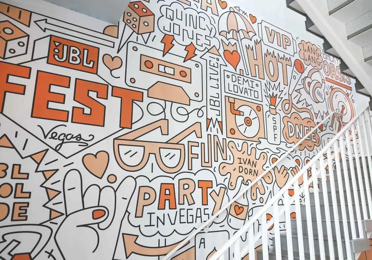 an orange and white wall that has some lettering on it with the words fest written in different languages