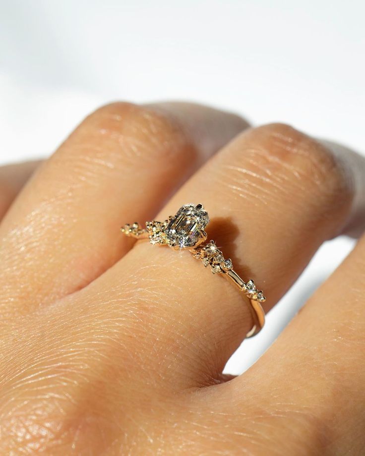 a woman's hand with a diamond ring on it