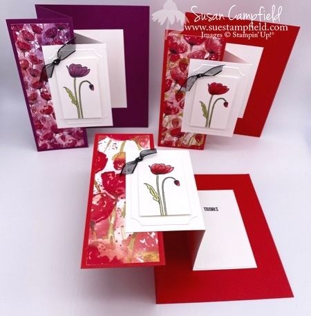 three cards with flowers on them are shown in red and purple colors, one has a bow at the top