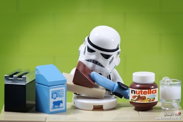 a toy stormtrooper is playing with some food