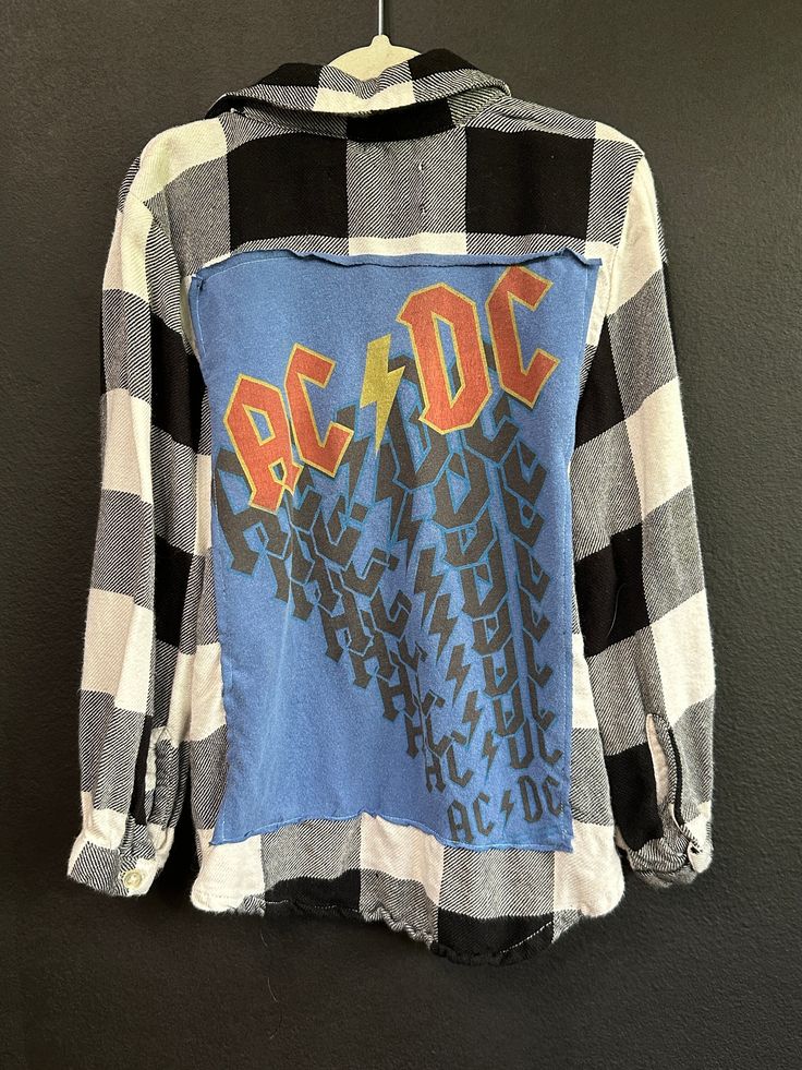 AC DC Flannel shirt. Perfectly imperfect! KIDS 5 for more specific sizing information reach out and I will measure! Plaid Cotton Tops With Letter Print, Blue Grunge Top For Fall, Long Sleeve Flannel Top With Graphic Print, Distressed Cotton Collared Tops, Distressed Collared Cotton Top, Fall Flannel Top With Graphic Print, Plaid Cotton Flannel Shirt With Graphic Print, Plaid Graphic Print Long Sleeve Shirt, Plaid Flannel Grunge Top