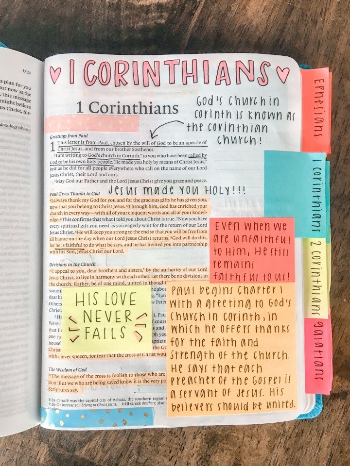 an open bible with colorful stickers on it and the words i corinthians