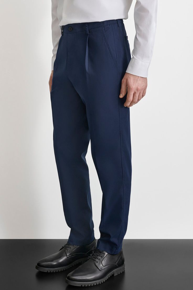 Button and zipper closure Belt loops Hem hits at ankle Pleated front DKNY logo at back Front and back pockets Elastic at waist 100% Polyester Machine wash Origins: Imported Style: M1440050 | DKNY Men's Pleated Front Pants in Blue Size Large Formal Tapered Leg Bottoms With Button Closure, Blue Business Casual Pants With Side Pockets, Blue Business Casual Bottoms With Side Pockets, Blue Pants With Side Pockets For Business Casual, Fitted Blue Pants With Button Zip Fly, Navy Full-length Bottoms With Welt Pockets, Full Length Navy Bottoms With Welt Pockets, Tailored Semi-formal Bottoms With Side Pockets, Semi-formal Tailored Bottoms With Side Pockets