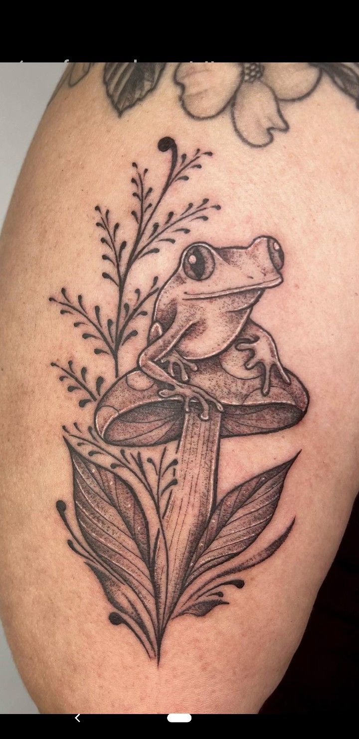 a frog sitting on top of a flower