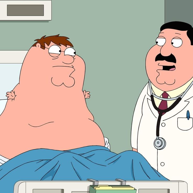 a man laying in a hospital bed next to a doctor