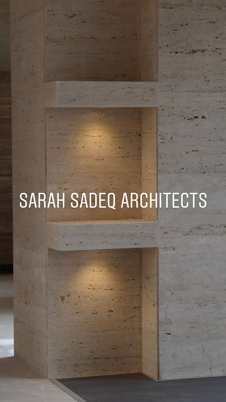 an empty room with shelves and lights on the wall above it that reads, sarah sadec architectures