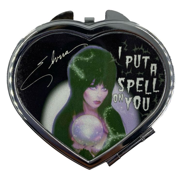 Elvira put a spell on you heart shaped compact, metal compact with non magnifying mirror inside, compact approx 2.75" w, exclusive bootique valentines deisgn. Printed in the USA Goth Gift Ideas, Tupac Pictures, Elvira Mistress Of The Dark, Autograph Books, Mary Berry, Magnifying Mirror, Sweater Layering, Hashtag Relatable, Thrift Finds