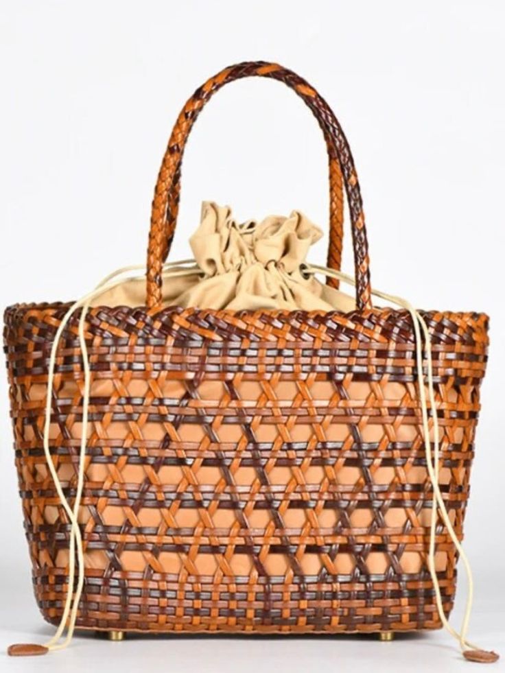 Casual style. Lightweight. Straw. Raffia natural fiber. Lined. Drawstring. Metal bottom accesories. Measurements are 24 cms. Length (9.44” inches) x 20cms height (7.87” inches) x 12 cms width (5" inches) Color may be lighter or darker depending of the device it is displayed. Chic Woven Leather Bags For Market, Elegant Summer Market Bag, Palm Leaf Straw Bag With Bamboo Handle, Chic Open Weave Straw Bag For Market, Elegant Woven Leather Beach Bag, Chic Natural Color Handheld Straw Bag, Casual Crochet Basket Bag With Bamboo Handle, Casual Brown Straw Bag With Bamboo Handle, Chic Woven Leather Straw Bag For Market