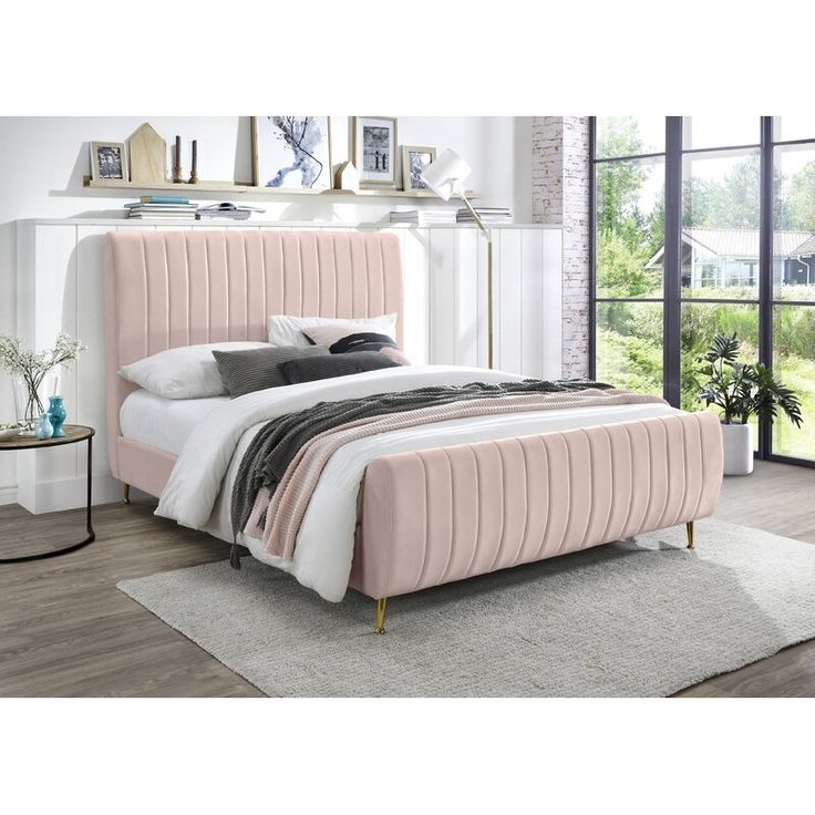 a bedroom with a pink bed and white walls