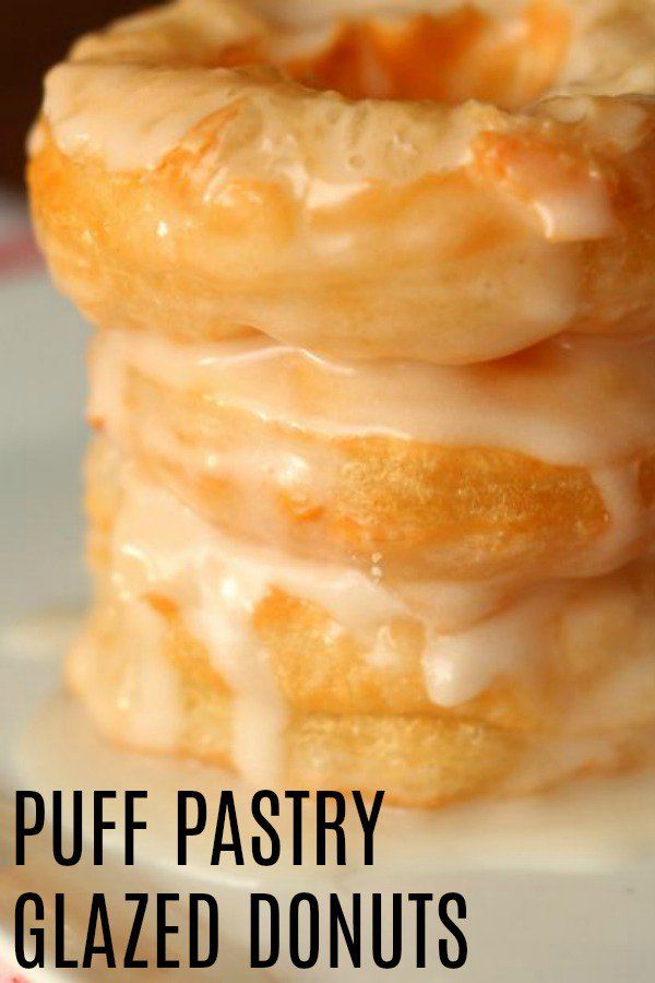 a stack of glazed donuts sitting on top of a white plate with the words puff pastry glazed donuts