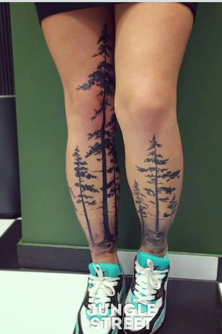 the legs and ankles of a woman with trees on them