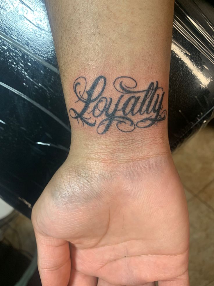 a person's hand with a tattoo on it that says loydallu