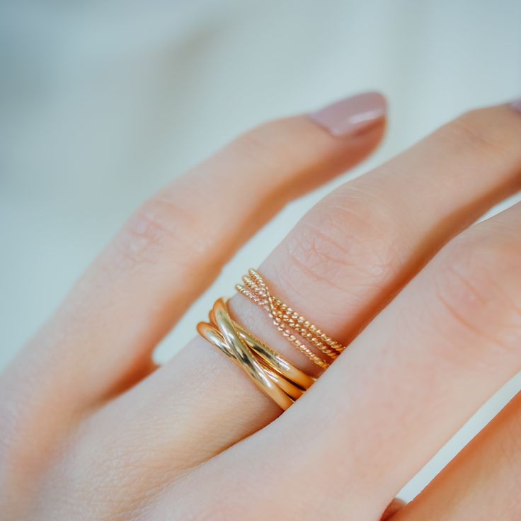 A bold, layered ring. This beautiful wrapped ring will become a staple in your wardrobe. This ring is handcrafted out of a D-shaped (half round) wire that is wrapped multiple times to create the appearance of three stacked rings. This listing is for ONE SINGLE ring in 14K GOLD. Made from Extra Thick 2mm metal. SIZING NOTE: Because this style is wider than a classic Stacking Ring, we recommend sizing up* by a QUARTER to a HALF size from your US Fashion Ring Size (Bridal size is different than US Elegant Twisted Stackable Rings As Gift, Elegant Twisted Stackable Promise Rings, Gold Double Band Stackable Rings With Modern Twist, Modern Twist Yellow Gold Stackable Rings, Modern Twist Yellow Gold Stackable Rings With Round Band, Yellow Gold Stackable Rings With Modern Twist, Modern Twist Gold Stackable Rings With Open Band, Modern Twist Stackable 14k Gold Rings, Modern Twist Stackable 14k Gold Midi Rings