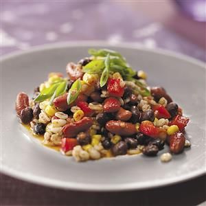 a white plate topped with beans and vegetables