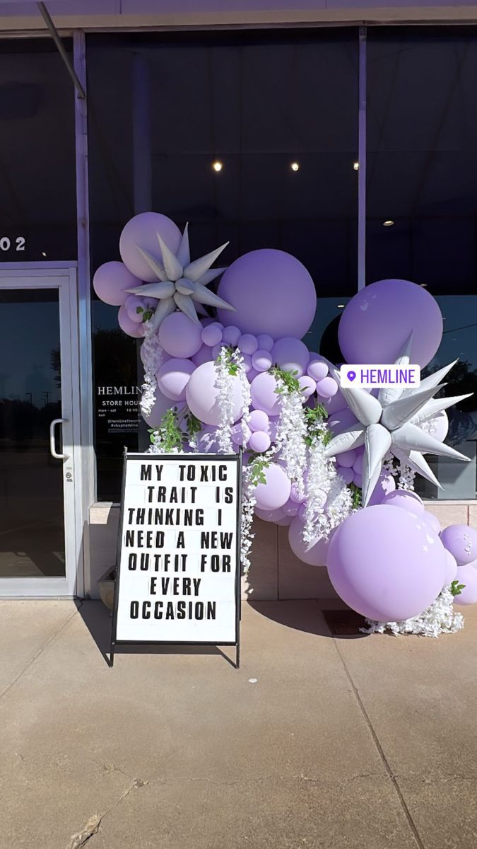 purple and white balloons in front of a building with a sign that says, may you be making a new decision