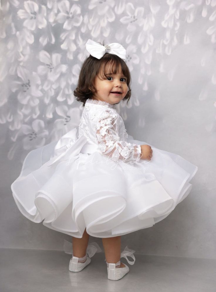 Baby white dress or ivory dress for first communion, baptism dress or first birthday - for any official celebration. A combination of a fluffy lower multi-layered skirt made of delicate tulle and a skirt top made of light flowing organza, a dress top made of voluminous lace with a small ruffle along the neckline. The dress is very interesting and stylish, like a light angelic cloud, in which the baby will look like a real pure and gentle angel The dress is available in two colors: white and ivor Tulle First Communion Dress With Ruffles, Elegant Ruffled Tutu Dress For First Communion, Ruffled Tutu Dress For First Communion, White Elegant Baptism Dress For First Birthday, Elegant White Baptism Dress For First Birthday, Princess Lace Tutu Dress For First Communion, Princess Style Lace Tutu Dress For First Communion, Lace Princess Tutu Dress For First Communion, White Organza Baptism Dress With Ruffles